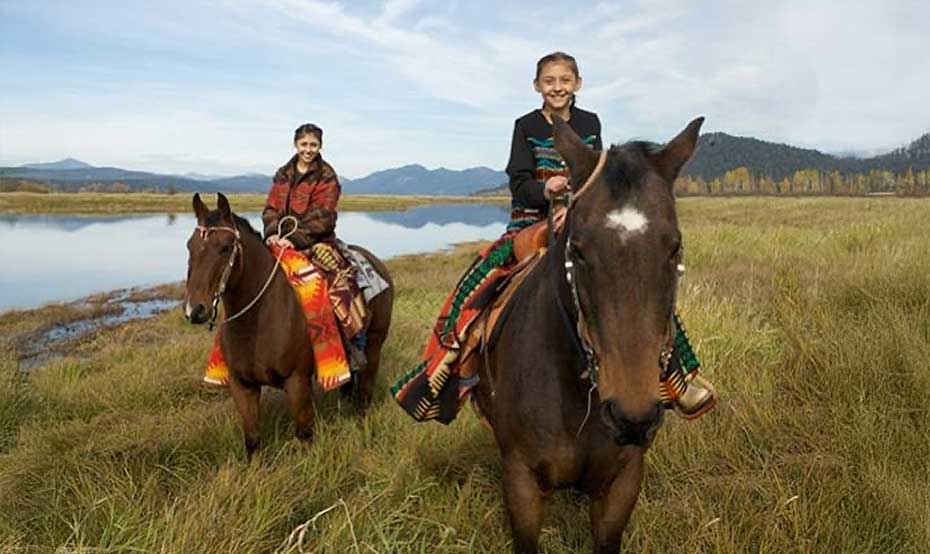The-Spirit-to-Succeed two kids on a horse with the river in the background